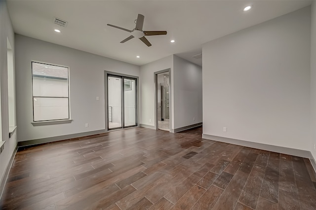 spare room featuring ceiling fan and dark wood-type flooring