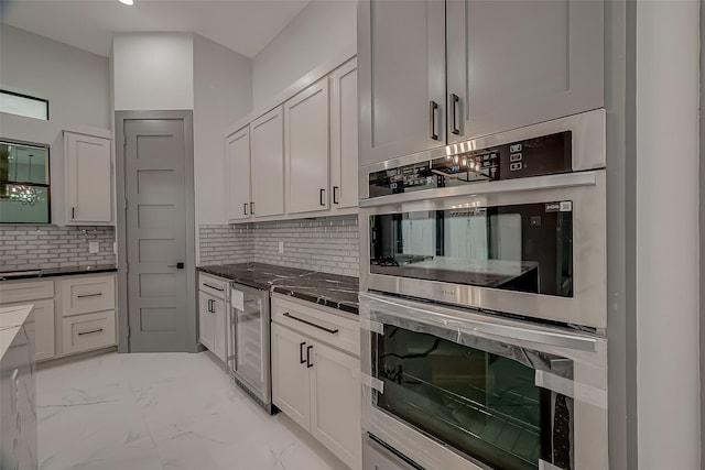 2322 Tuam, Houston, TX 77004 - kitchen with double oven, light marble finish floors, tasteful backsplash, beverage cooler, and white cabinetry