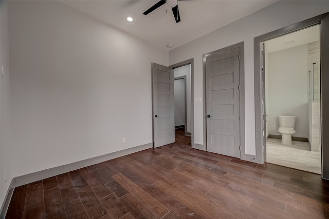 unfurnished bedroom with ceiling fan, ensuite bathroom, and hardwood / wood-style floors