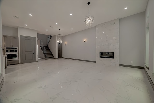 unfurnished living room with a fireplace, an inviting chandelier, and heating unit