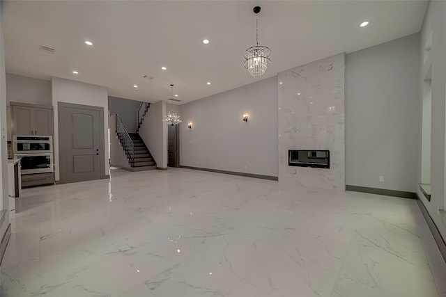 2322 Tuam, Houston, TX 77004 - unfurnished living room featuring a chandelier, recessed lighting, heating unit, stairs, and light marble finish flooring