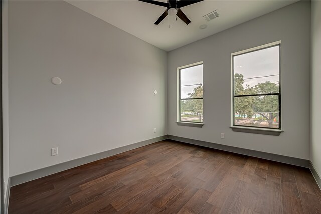 unfurnished room featuring ceiling fan and dark wood-type flooring