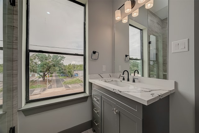 bathroom featuring a wealth of natural light and vanity