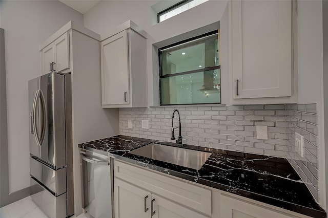 2322 Tuam, Houston, TX 77004 - kitchen with stainless steel fridge with ice dispenser, backsplash, white cabinets, and dark stone counters