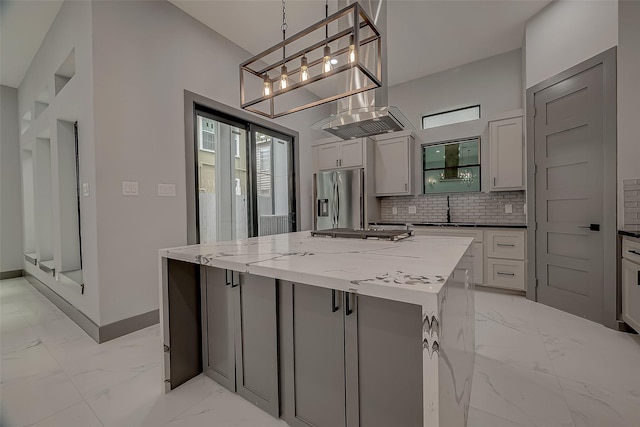 2322 Tuam, Houston, TX 77004 - kitchen with stainless steel appliances, light marble finish floors, tasteful backsplash, a center island, and a chandelier