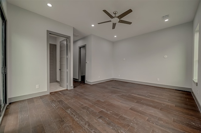 unfurnished bedroom with ensuite bath, ceiling fan, and dark hardwood / wood-style flooring