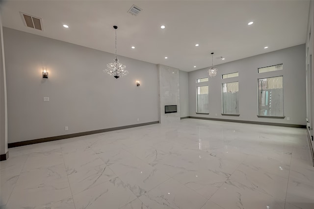 unfurnished living room with a chandelier