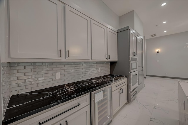 2322 Tuam, Houston, TX 77004 - kitchen with beverage cooler, recessed lighting, white oven, light marble finish flooring, and backsplash