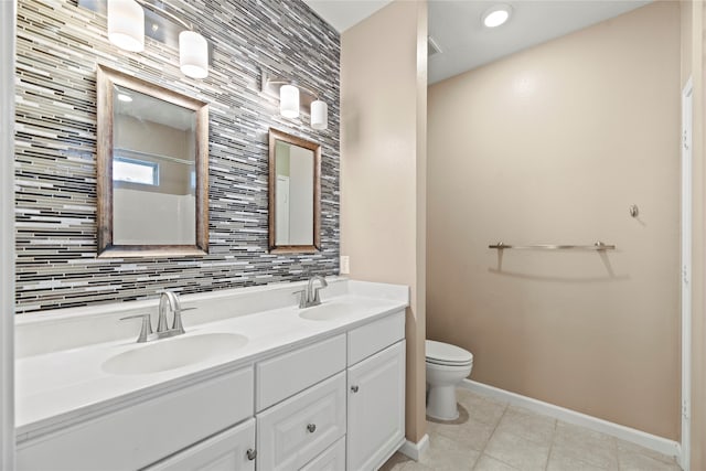 bathroom with decorative backsplash, toilet, vanity, and tile patterned flooring