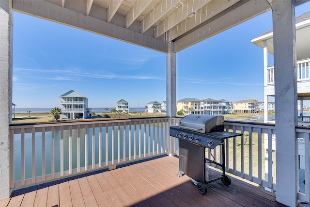 deck featuring a water view and grilling area