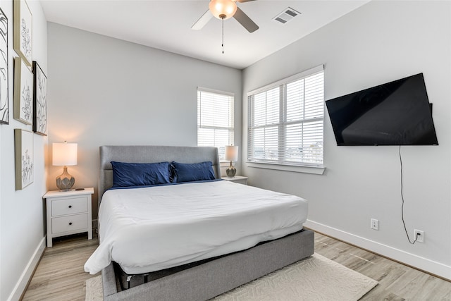 bedroom with light hardwood / wood-style floors and ceiling fan