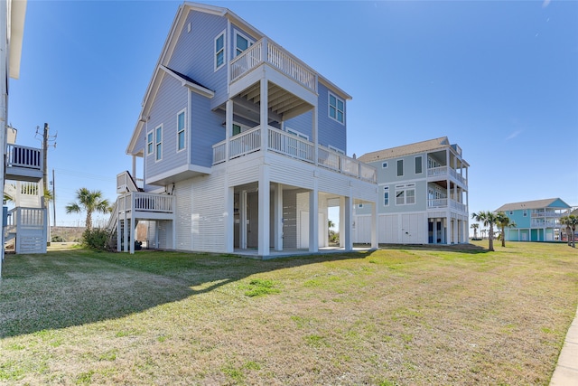 back of house featuring a balcony and a lawn