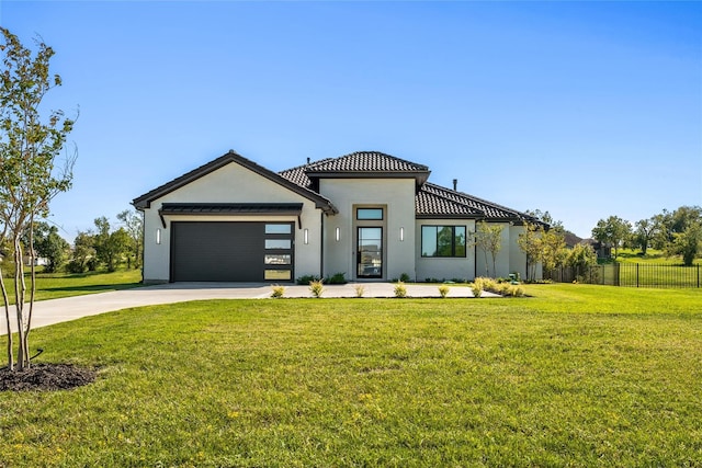 view of front of home featuring a front lawn and a garage