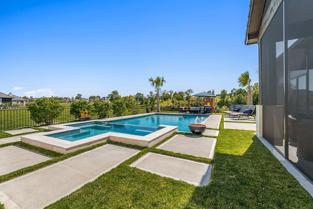 view of swimming pool featuring a yard, an in ground hot tub, and a patio