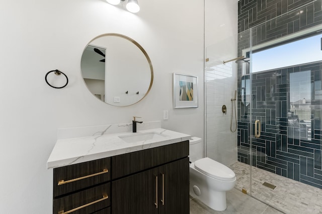 bathroom featuring tile patterned floors, vanity, walk in shower, and toilet