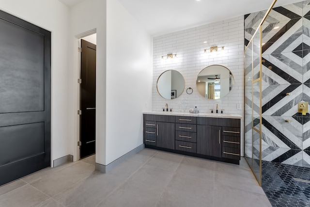 bathroom with backsplash, a shower with shower door, vanity, and tile walls