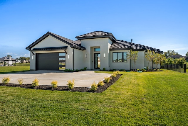 view of front of house with a front lawn and a garage