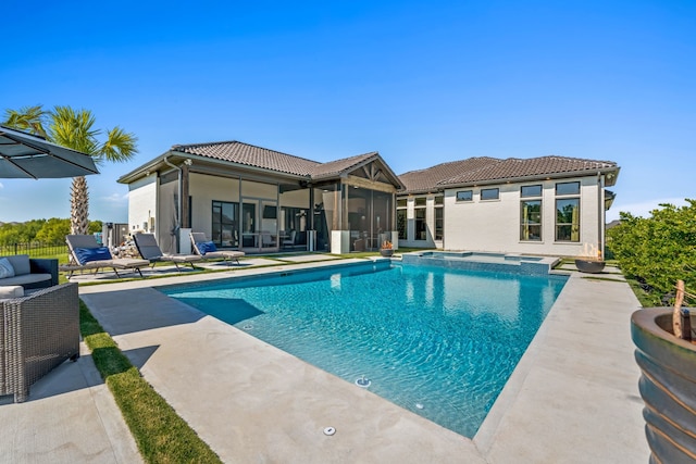 view of pool featuring a sunroom and a patio area