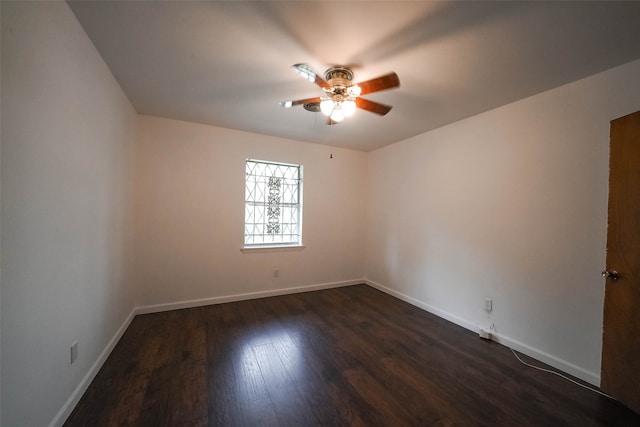 spare room with ceiling fan and dark wood-type flooring