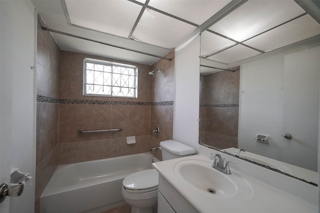 full bathroom with vanity, toilet, and tiled shower / bath combo