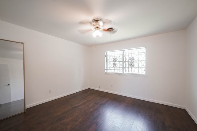 spare room featuring dark hardwood / wood-style floors and ceiling fan