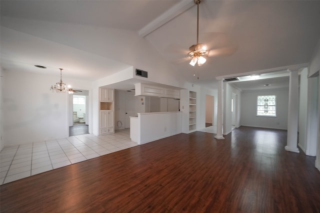 unfurnished living room featuring ceiling fan with notable chandelier, vaulted ceiling with beams, light hardwood / wood-style floors, and built in features