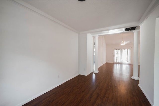 unfurnished room featuring decorative columns, crown molding, a chandelier, and dark hardwood / wood-style flooring