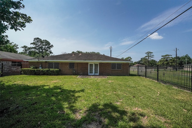 rear view of property with a yard