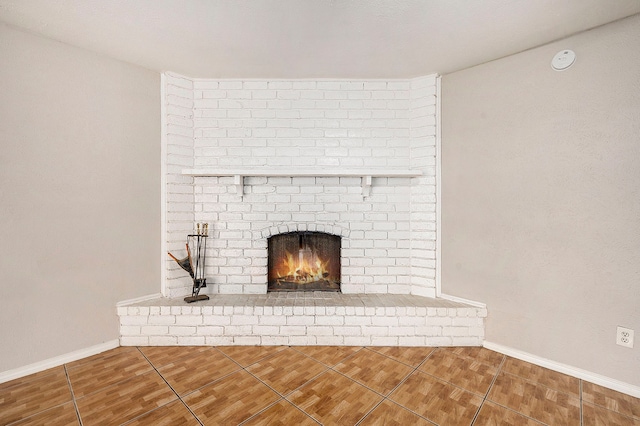 interior details featuring a brick fireplace and tile patterned floors