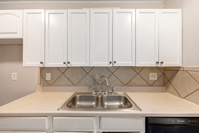 kitchen featuring backsplash, white cabinetry, sink, and dishwasher