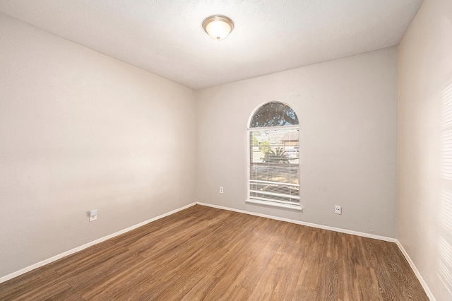 unfurnished room featuring hardwood / wood-style flooring