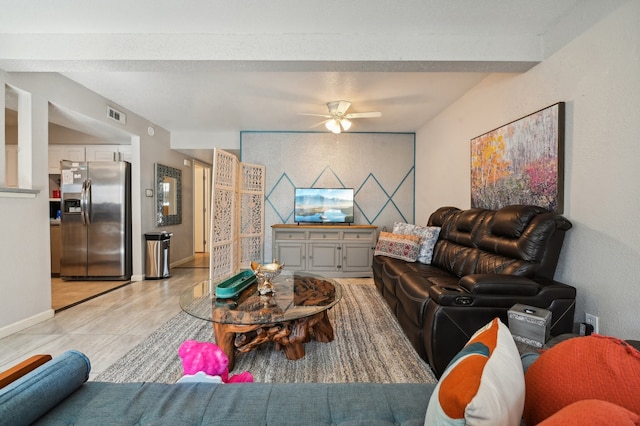 living room featuring light tile patterned floors and ceiling fan