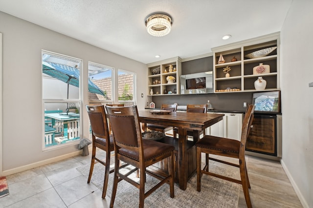 tiled dining space with a textured ceiling