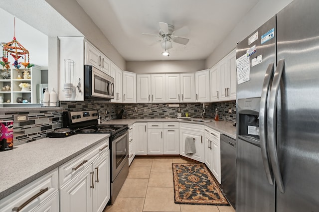 kitchen featuring appliances with stainless steel finishes, decorative backsplash, sink, and white cabinets