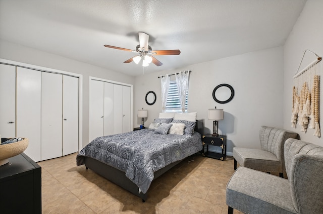 tiled bedroom featuring multiple closets and ceiling fan