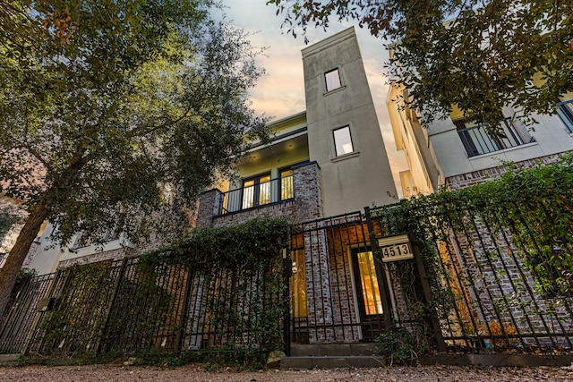 view of outdoor building at dusk