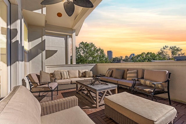 patio terrace at dusk with an outdoor living space and ceiling fan