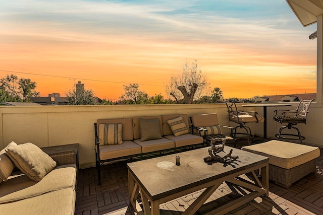 patio terrace at dusk featuring an outdoor hangout area