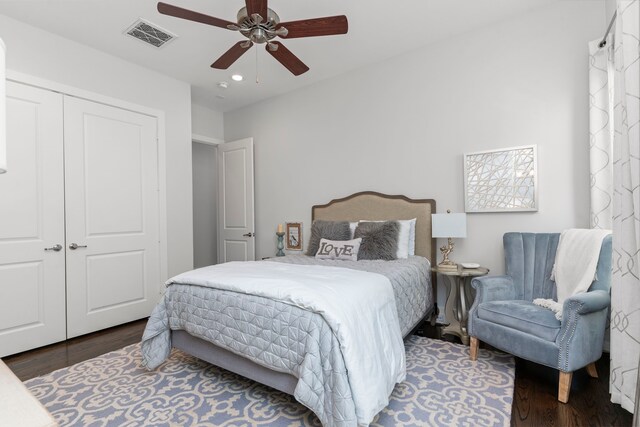 bedroom featuring ceiling fan, a closet, and dark hardwood / wood-style floors