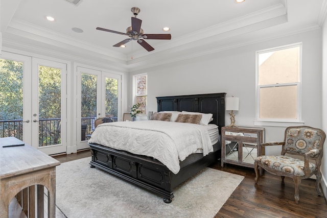 bedroom with access to exterior, dark wood-type flooring, ornamental molding, and a raised ceiling