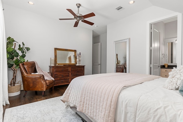 bedroom featuring ceiling fan, dark hardwood / wood-style flooring, lofted ceiling, and ensuite bathroom