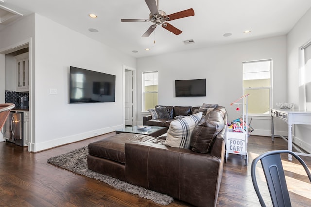 living room with ceiling fan and dark hardwood / wood-style floors