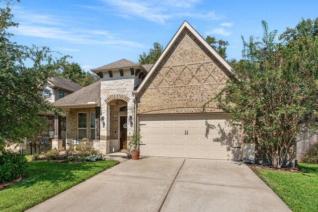 view of front of home with a front lawn and a garage