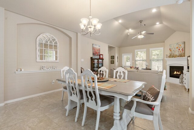 dining room featuring lofted ceiling and ceiling fan with notable chandelier