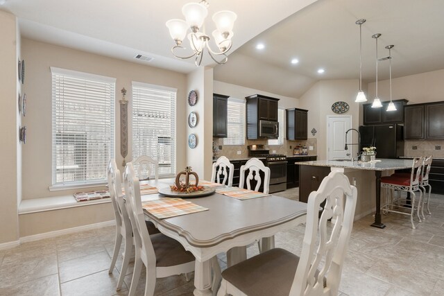 tiled dining area with a notable chandelier and vaulted ceiling