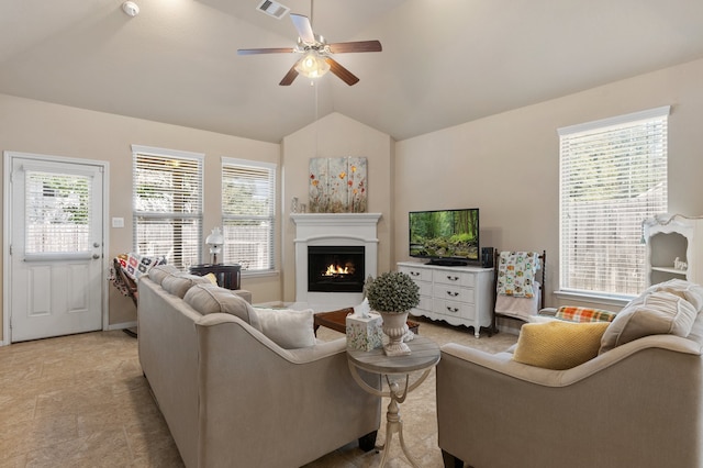 living room featuring ceiling fan and vaulted ceiling