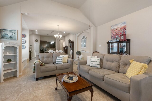 living room with a notable chandelier and vaulted ceiling