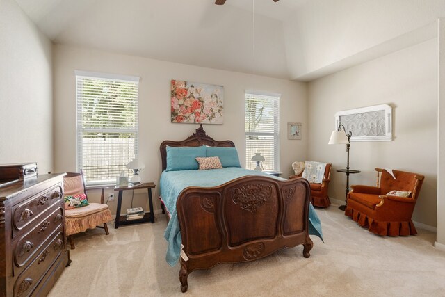 carpeted bedroom with ceiling fan, vaulted ceiling, and multiple windows