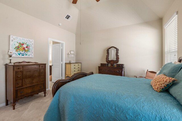 bedroom featuring light carpet, lofted ceiling, and ceiling fan