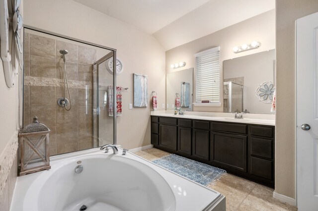 bathroom featuring vanity, tile patterned floors, lofted ceiling, and plus walk in shower